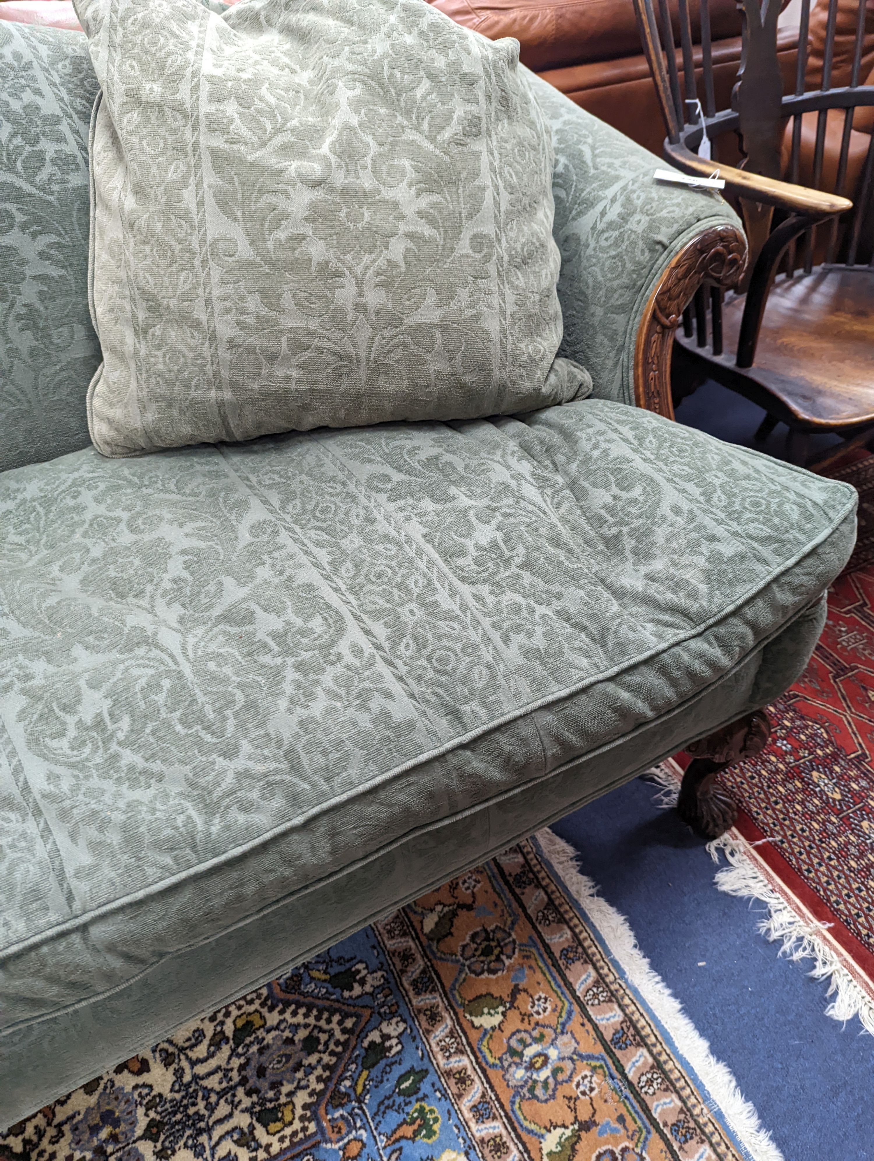 A George I style upholstered carved walnut settee on shell carved cabriole claw feet, length 220cm, depth 80cm, height 94cm